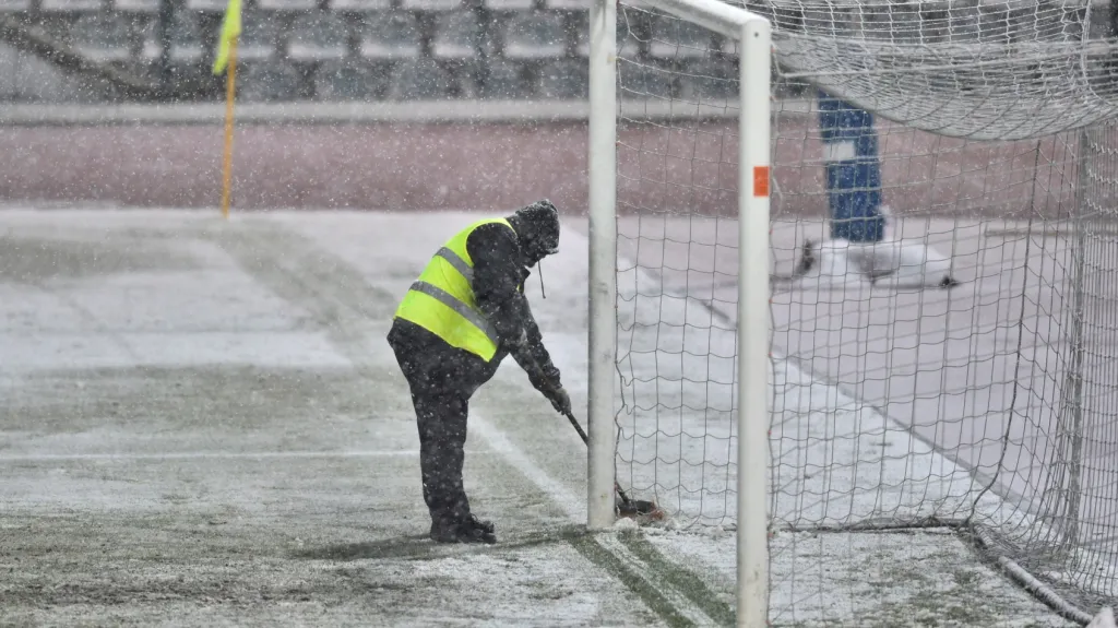 Pořadatel shrabuje sníh na Julisce před utkáním Dukla - Sparta