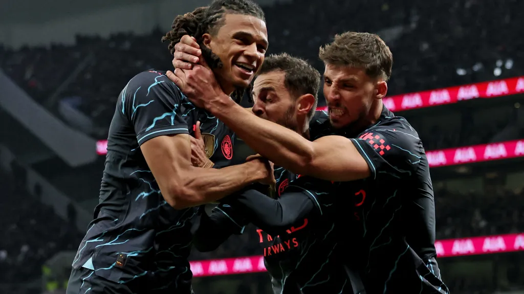 Nathan Aké se raduje se spoluhráči z Manchesteru City Bernardem Silvou a Rúbenem Diasem