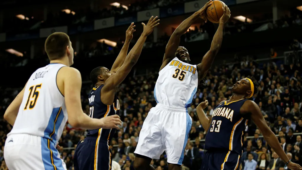 Kenneth Faried z Denveru se snaží prosadit přes hráče Indiany
