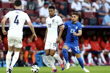 Anglický záložník Jude Bellingham si kryje míč před Slovincem Adamem Gnezdou Čerinem