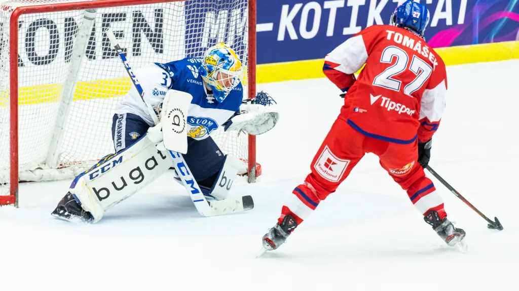 Finský gólman Janne Juvonen čelí nájezdu Davida Tomáška