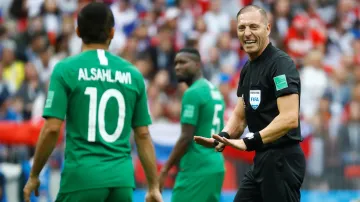 Rozhodčí Néstor Pitana diskutuje s Muhammadem Šahlávím ze Saúdské Arábie