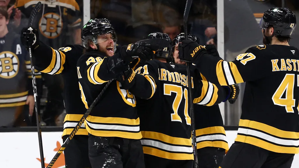 David Pastrňák slaví gól se spoluhráči z Bruins