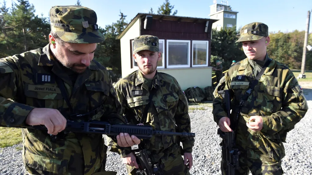 Střelec Tomáš Těhan stojí na fotografii uprostřed