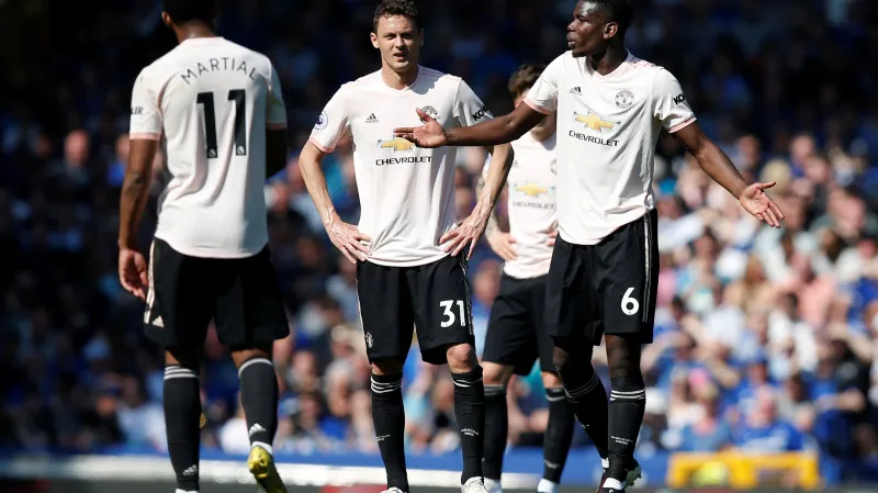 Paul Pogba (vpravo) v diskuzi se spoluhráči z Manchesteru United