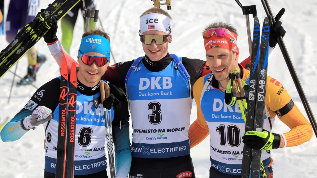 Vítězný Johannes Thingnes Bö v objetí s Emilienem Jacquelinem (vlevo) a Arndem Peifferem