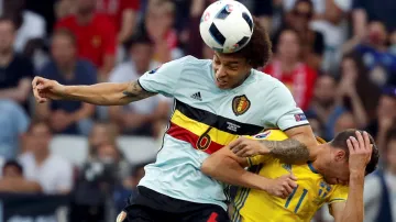 Belgičan Axel Witsel v hlavičkovém souboji se Švédem Marcusem Bergem