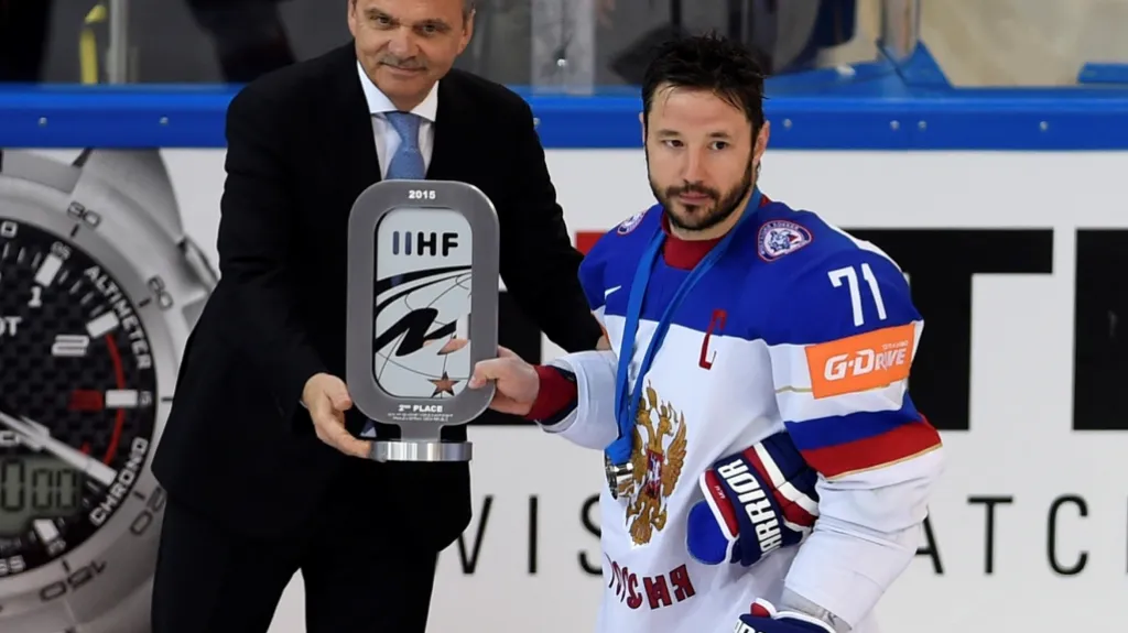 Ilja Kovalčuk z Ruska (vpravo) přebírá pohár za druhé místo od prezidenta mezinárodní hokejové federace Reného Fasela